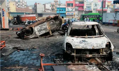  ??  ?? Burnt-out vehicles following clashes in New Delhi Photograph: Sajjad Hussain/AFP via Getty Images