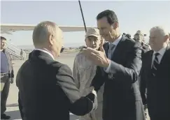  ??  ?? 0 President Assad greets Vladimir Putin on his arrival in Syria