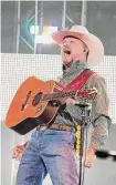  ?? Karen Warren/Staff photograph­er ?? Cody Johnson wows a crowd of over 73,000 Friday at the Houston Livestock Show and Rodeo at NRG Stadium.