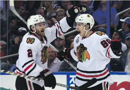  ?? BRUCE BENNETT/GETTY IMAGES ?? Chicago Blackhawks centre Teuvo Teravainen, right, celebrates his third-period goal against the Tampa Bay Lightning with defenceman Duncan Keith during Game 1 of the Stanley Cup final on Wednesday in Tampa, Fla. Teravainen also had an assist in the 2-1...