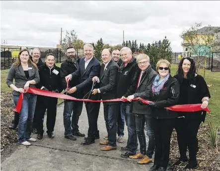  ??  ?? Builders and developers were all smiles at the Woodbend grand opening in Leduc on Sept. 29.