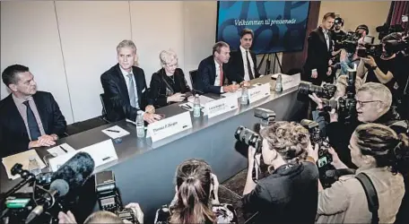  ?? Mads Claus Rasmussen AFP/Getty Images ?? DANSKE BANK officials speak Wednesday about a money-laundering scandal. Thomas Borgen, second from left, stepped down as CEO.