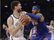  ?? FRANK FRANKLIN II — ASSOCIATED PRESS ?? Nets’ Brook Lopez, left, and Knicks’ Carmelo Anthony battle for the ball during Brooklyn’s victory over New York.