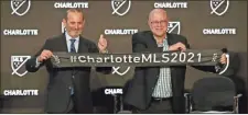  ?? AP-Nell Redmond ?? Major League Soccer Commission­er Don Garber, left, and Charlotte MLS team owner David Tepper announce that Major League Soccer will be coming to Charlotte in 2021 at an event in Charlotte, N.C., on Tuesday.