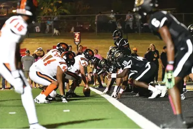  ?? Photo by Kevin Sutton ?? ■ Gilmer's offense (white uniforms) prepares to run a play against the Pleasant Grove defense just outside the end zone Friday at Hawk Stadium. Gilmer defeated the Hawks, 35-14, in the District 7-4A, Division II opener.