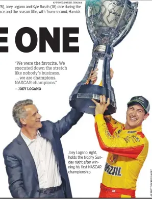  ??  ?? Joey Logano, right, holds the trophy Sunday night after winning his first NASCAR championsh­ip.