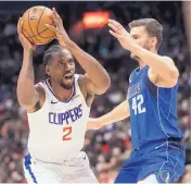  ?? DARRYL DICK/THE CANADIAN PRESS VIA AP ?? Kawhi Leonard (2), shown during a preseason game against Dallas, made the Clippers a title contender with his move from Toronto to LA this offseason.