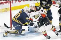  ?? Jeffrey T. Barnes Associated Press ?? RICKARD RAKELL, who scored the Ducks’ first goal, skates past Buffalo goalie Robin Lehner in the third period.