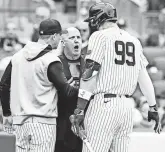  ?? WENDELL CRUZ/USA TODAY SPORTS ?? Yankees manager Aaron Boone and Aaron Judge argue with umpire Ryan Blakney.