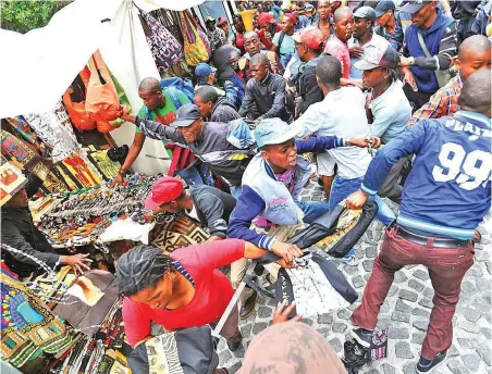  ?? PICTURE: MATTHEW JORDAAN ?? SIMMERING DISCONTENT: What started as a housing protest at the provincial legislatur­e turned ugly when groups began running amok, looting Greenmarke­t Square and stalls in St George’s Mall in October 2013.