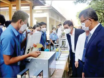  ?? HENG CHIVOAN ?? Education minister Hang Chuon Naron (far right) visits an electronic­s exhibition showcasing student projects in Phnom Penh’s Por Sen Chey district in June 2022.