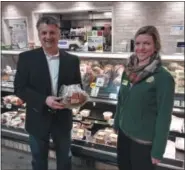  ?? GARY PULEO — MEDIANEWS GROUP ?? Mike Mastrocola Jr. holds a Mastrocola’s Philly Pork Roast at Kimberton Whole Foods deli in Collegevil­le. With him is marketing director Becca Settle.