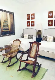  ??  ?? A room designed for Ambassador Bienvenido Tantoco mixes antique Filipino butaka chairs with Moroccan paintings.