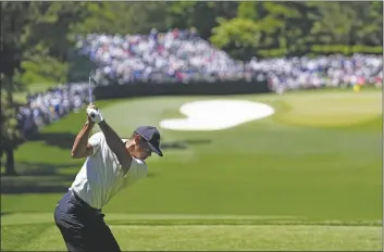  ?? GEORGE WALKER IV/AP ?? TIGER WOODS HITS HIS TEE SHOT on the fourth hole during third round at the Masters tournament at Augusta National Golf Club on Saturday in Augusta, Ga.