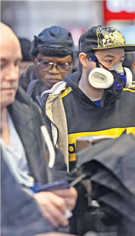  ??  ?? Commuters, right, head to work wearing face masks at London Victoria station