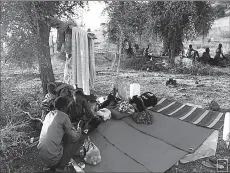  ?? -REUTERS ?? Ethiopians who fled war in Tigray region, rest under trees with their belongings at the Um-Rakoba camp on the Sudan-Ethiopia border in Al-Qadarif state, Sudan.