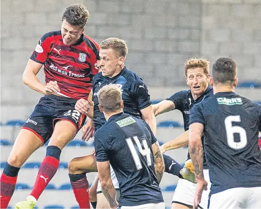  ?? Picture: SNS Group. ?? Jack Hendry rises above the Rovers defence to head home Dundee’s stoppage-time winner.