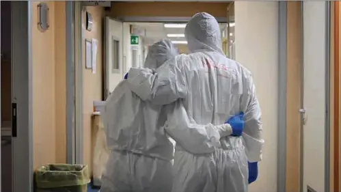  ?? ?? File photo dated April 20, 2020 shows Doctor Marco (right) and nurse Manu, wearing protective gear react at the end of their shift in a corridor of the level intensive care unit, treating COVID-19 patients, at the San Filippo Neri hospital in Rome.