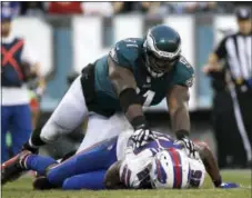  ?? MICHAEL PEREZ — THE ASSOCIATED PRESS ?? Eagles defensive end Fletcher Cox, coming in for a landing last December onto former teammate LeSean McCoy of the Buffalo Bills, has shown that he’s not one to talk about individual accolades.