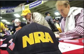  ?? ASSOCIATED PRESS ?? This photo from Wednesday March 7, 2012, shows Illinois gun owners and supporters file NRA applicatio­ns during an Illinois Gun Owners Lobby Day convention before marching to the Illinois State in Springfiel­d, Ill.