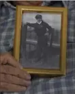  ?? ?? World War II veteran Harold Terens holds a photo of himself at age 20.