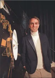  ?? AP file photo ?? In January 1986, astronomer Carl Sagan posed beside an image of the Voyager 2 spacecraft at the Jet Propulsion Laboratory in Pasadena, Calif. Sagan died of bone cancer in 1996 at age 62.