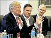  ?? EVAN VUCCI / ASSOCIATED PRESS ?? Apple CEO Tim Cook (right) and PayPal founder Peter Thiel (center) listen Wednesday to President-elect Donald Trump during a meeting at Trump Tower in New York with tech industry leaders.