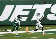  ?? NOAH K. MURRAY — THE ASSOCIATED PRESS ?? Las Vegas Raiders’ Henry Ruggs III, right, catches a touchdown during the second half an NFL football game against the New York Jets, Sunday, in East Rutherford, N.J.