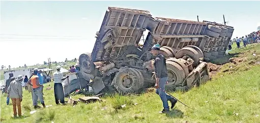  ??  ?? HORRIFIC: Carnage greeted passers-by after two bakkies collided head-on with a truck on the road between Mthatha and Ngqeleni in the Eastern Cape.