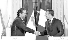  ??  ?? Macron (right) shaking hands with Hariri during a press conference at the Murat Lounge in the Elysee Palace in Paris in this file photo. — AFP photo