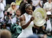  ?? BEN CURTIS — THE ASSOCIATED PRESS FILE ?? In this file photo, Serena Williams holds her trophy after winning the women’s singles final against Angelique Kerber of Germany at the Wimbledon Tennis Championsh­ips in London. Serena Williams was seeded No. 25 for her return to Wimbledon after having a baby, a decision by the All England Club announced Wednesday that elevates the tournament’s seven-time champion above her ranking of 183rd.