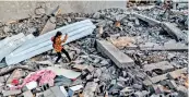  ?? — AFP ?? A girl walks through rubble in Gaza Strip’s Rafah after reported Israeli air strikes overnight.