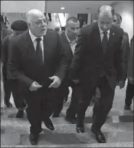  ?? AP/KARIM KADIM ?? Iraqi Prime Minister Haider al-Abadi (left) arrives Wednesday for a session of the Iraqi parliament in Baghdad. Al-Abadi ordered the Kurdish region to hand over control of its airports to federal authoritie­s or face a flight ban.