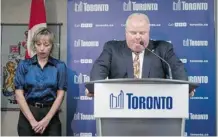  ?? The Canadian Press/Files ?? The antics of Toronto Mayor Rob Ford, seen apologizin­g as his wife Renata looks on, are detailed in a book and could become a movie.