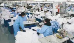  ??  ?? Workers producing protective clothing at a factory in Wuxi, in China’s eastern Jiangsu province. The factory, which previously produced suits and sportswear, switched to production of protective clothing as demand increases due to the ongoing coronaviru­s outbreak. – AFPPIX