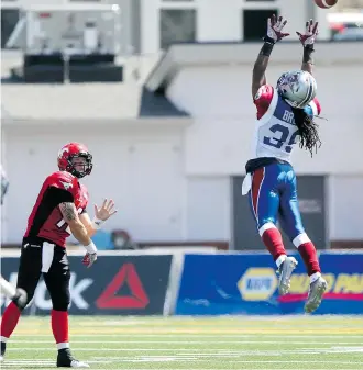  ?? Lorraine Hjalte/Calgary Herald ?? Montreal’s Jerald Brown leap to block quarterbac­k Bo Levi Mitchell’s throw in Calgary’s 29-8 win over the Alouettes on June 28 at McMahon Stadium. The Stamps haven’t played since then.