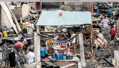  ?? —JAMSTA. ROSA ?? PICKING UP THE PIECES Residents of Barangay Catmon, Malabon City gather whatever materials they can salvage from what remained of their houses after a five-hour fire razed the area on Thursday.