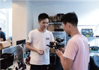  ??  ?? A young entreprene­ur (left) examines a product with a team member in Qianhai, Shenzhen, Guangdong Province in south China, on November 5, 2019