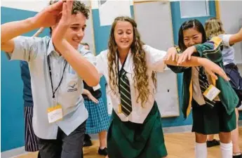  ??  ?? Highfields State Secondary College student Eligh Dungey (left) with Centenary Heights State High School students Holly Lee (centre) and Honoka Murata learn theatre.