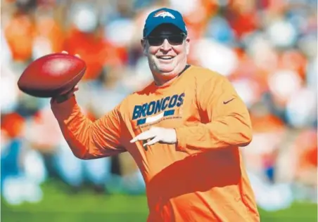  ?? Associated Press file ?? Bill Musgrave, seen at training camp showing the throwing mechanics that earned him the 1985 Denver Post Gold Helmet award, will take over as the team’s offensive coordinato­r from Mike McCoy, who was fired Monday.