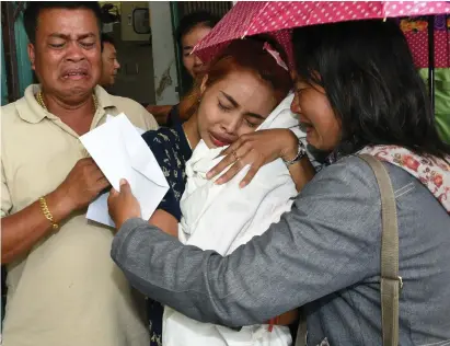  ??  ?? Jiranuch Trirat holds the body of her 11-month-old daughter Natalie, who was killed by her father who broadcast the murder on Facebook. Photo: Reuters