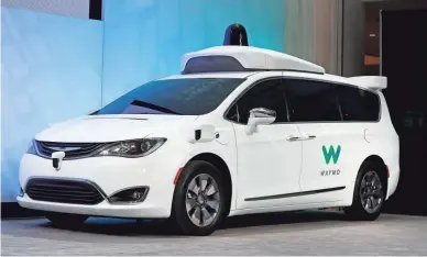  ?? PAUL SANCYA/AP ?? In this Jan. 8, 2017, file photo a Chrysler Pacifica hybrid outfitted with Waymo’s suite of sensors and radar is displayed at the North American Internatio­nal Auto Show in Detroit. Right now, there is no car on sale that can drive itself without requiring the driver to pay attention to the road and be prepared to take control of the vehicle. In fact, some automakers have slowed down their timelines.