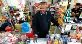  ?? ASSOCIATED PRESS FILE PHOTO ?? Carl Lewis works in his market in Rankin, Pa. About half of Lewis' customers pay with benefits from the federal Supplement­al Nutrition Assistance Program, so the government's proposal to replace the debit card-type program with a pre-assembled box of...