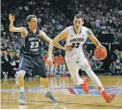  ?? JOHN LOCHER/THE ASSOCIATED PRESS ?? Gonzaga’s Kyle Wiltjer, right, drives around BYU’s Skyler Halford during the first half of the West Coast Conference tournament championsh­ip Tuesday in Las Vegas, Nev.