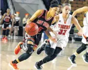  ??  ?? Tulsa Washington’s Camryn Fennell drives past Coweta’s Madison Wheat in a Class 5A state semifinal Friday in Tulsa.