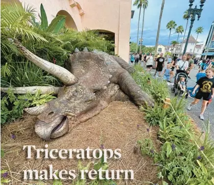  ?? DEWAYNE BEVIL/ORLANDO SENTINEL ?? A model of a triceratop­s rests outside the “Jurassic Park”-themed Tribute Store at Universal Studios. The dinosaur, once part of the theme park’s Boneyard attraction, has been at Give Kids the World Village for the past 20 years.