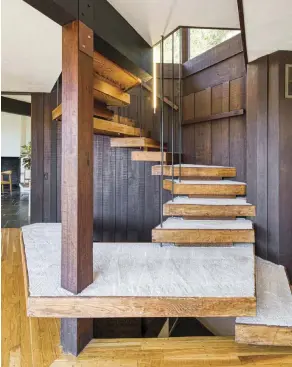  ??  ?? RIGHT: THE SPIRAL STAIRCASE IS ARCHITECTU­RALLY STUNNING AND, AS GARRETT SAYS, “IS THE MOST SALIENT FEATURE AND FOCUS OF THE HOME.”