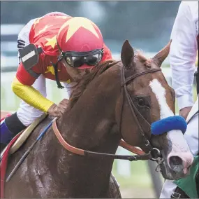  ?? Skip Dickstein / Albany Times Union ?? Jockey Mike Smith gives Justify a kiss after holding off the competitio­n and winning the 150th running of the Belmont Stakes and the Triple Crown on Saturday.