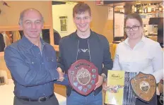  ??  ?? Player of the year James Dougan (centre) receives his trophy from club president Walter McAllister and Ruta Pavyolyte, manageress of Rana’s in Bridge of Allan
