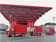  ??  ?? The three lorries pass the China Art Museum in Shanghai